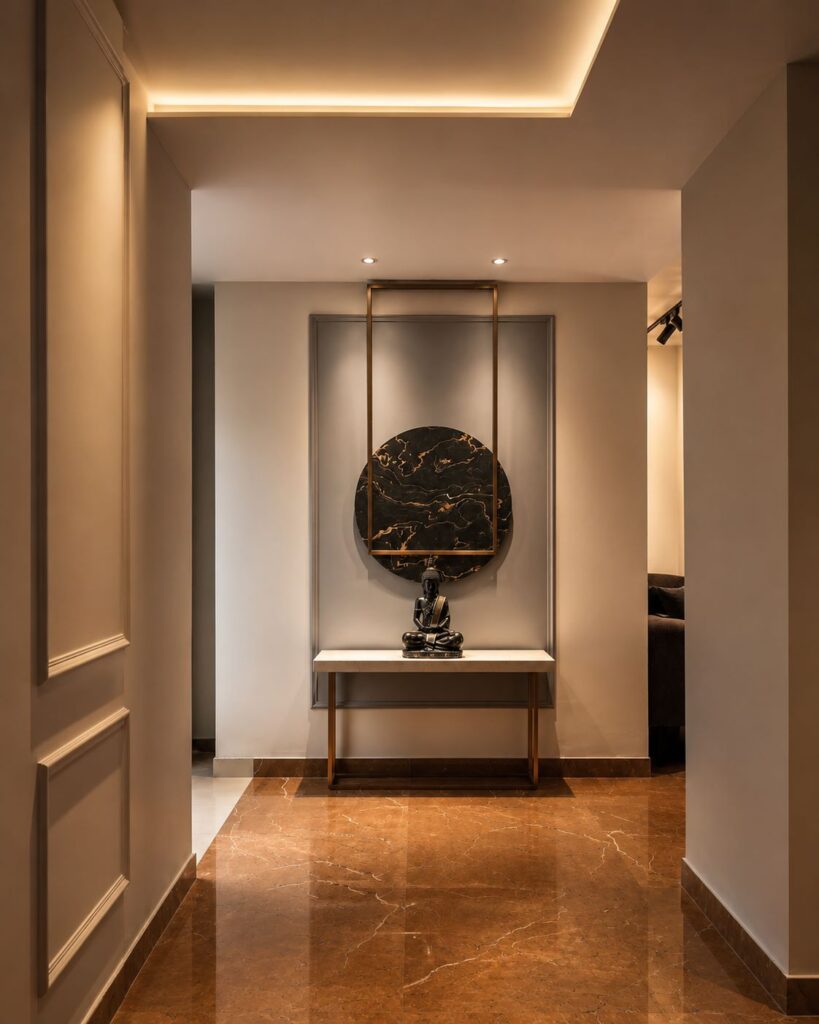 Luxury entrance foyer design with white marble console table, seated Buddha statue, circular black marble wall art, and brass frame by Urban Box Studio