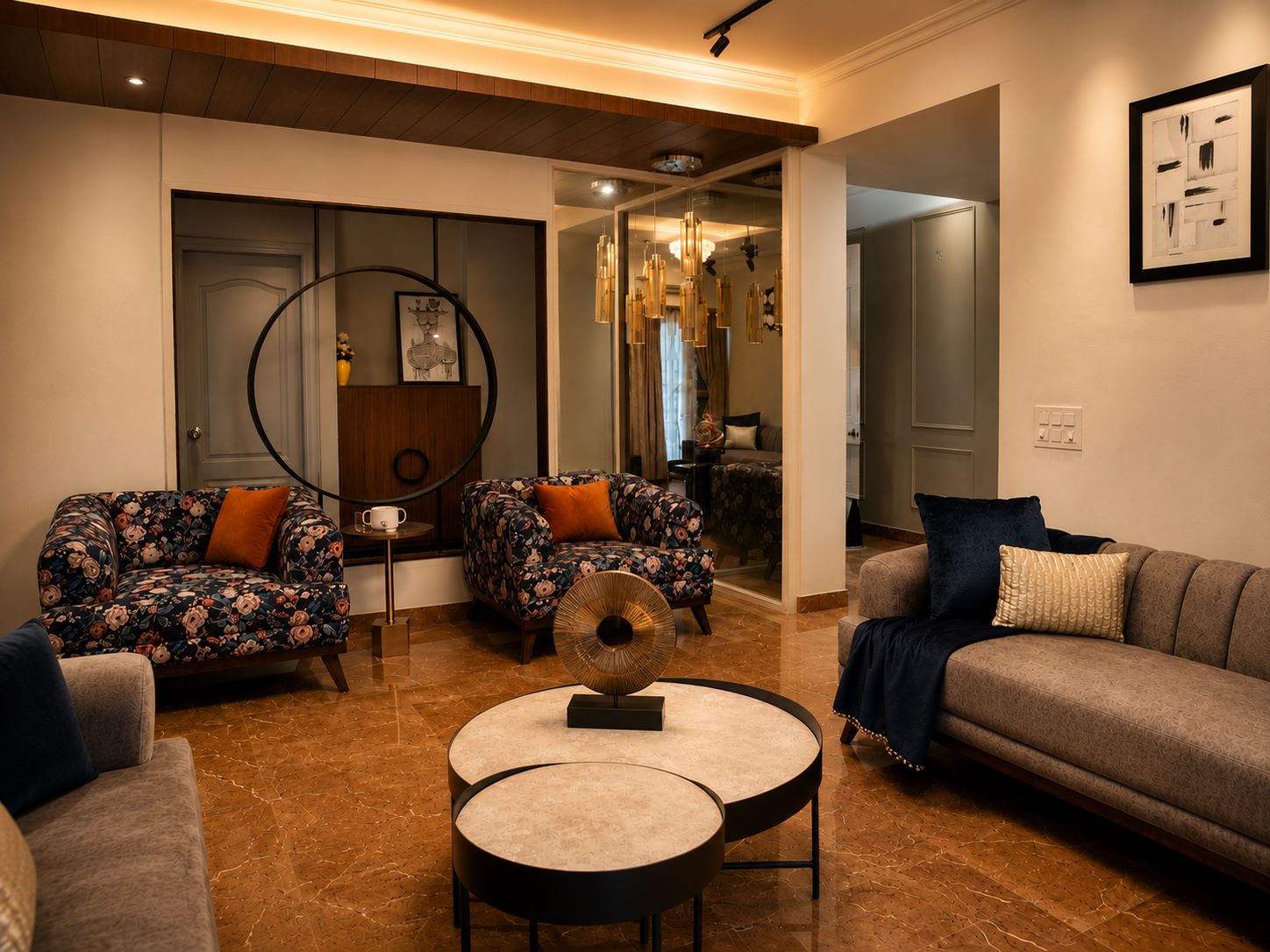 Luxury living room interior featuring printed floral armchairs, nested coffee tables, tufted sofa, and glass pendant chandelier by Urban Box Studio