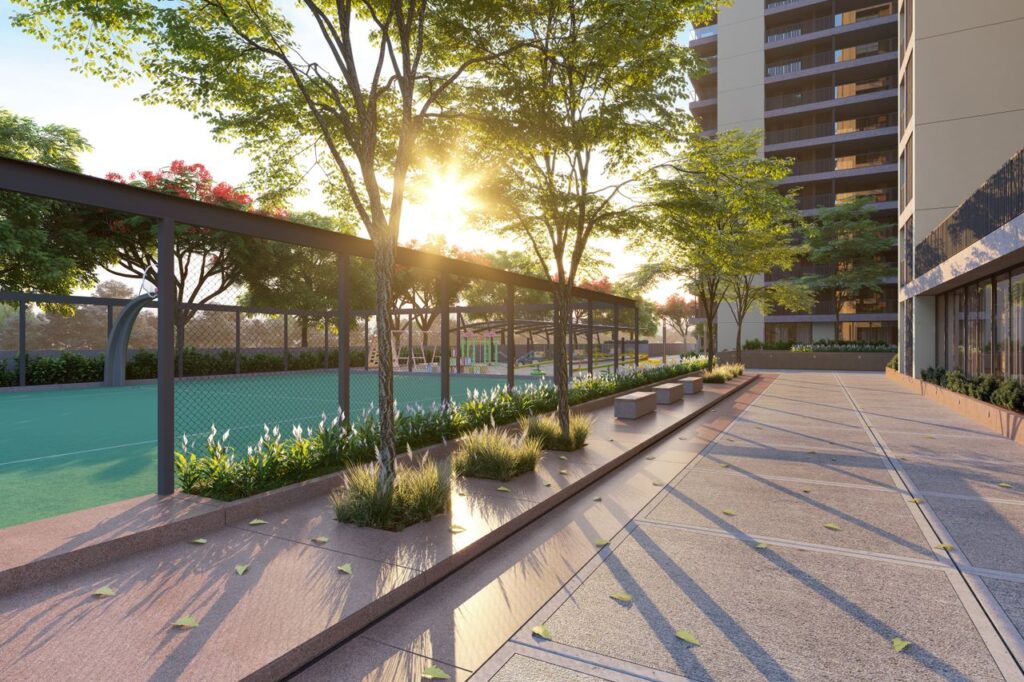 A residential complex with tennis court and garden in a sunny setting.