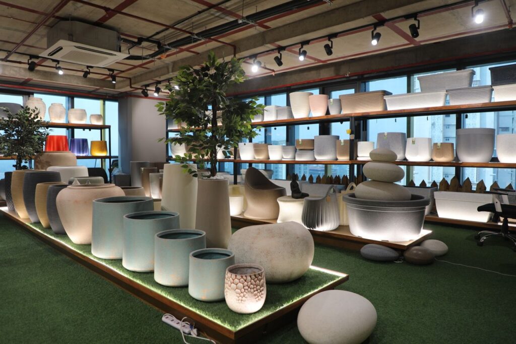 A spacious showroom featuring an array of stylish indoor planters and pots on display.
