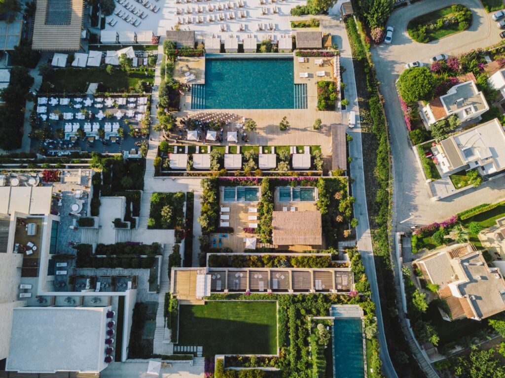 Stunning birds-eye view of a luxurious resort featuring lush gardens and sparkling pools.